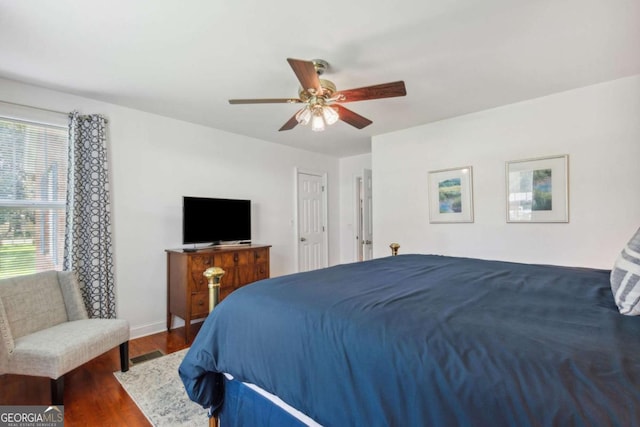 bedroom with visible vents, ceiling fan, baseboards, and wood finished floors