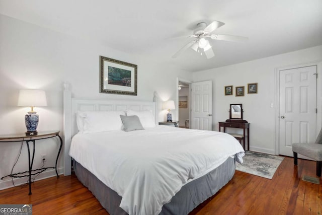 bedroom featuring a ceiling fan, baseboards, and wood finished floors