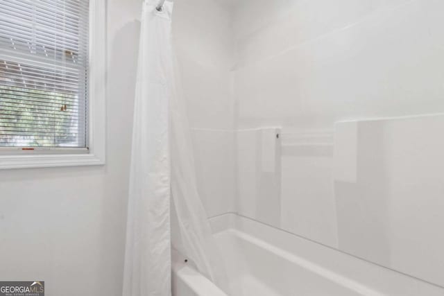 full bathroom with shower / tub combo with curtain