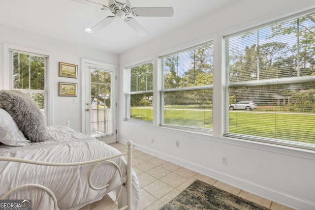 bedroom featuring access to outside, light tile patterned floors, baseboards, and ceiling fan