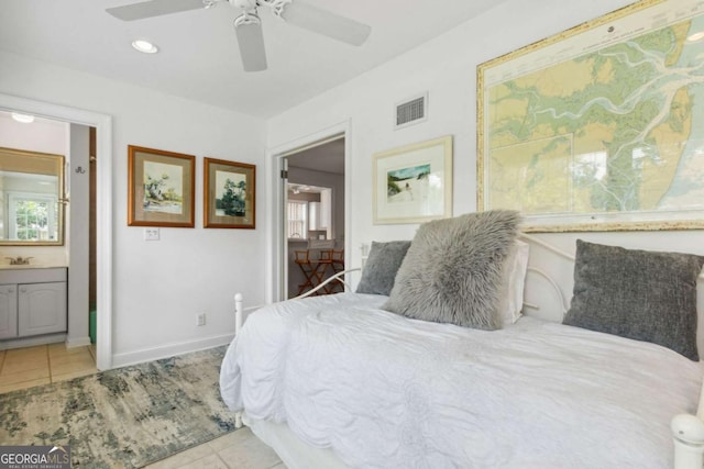 tiled bedroom featuring ensuite bath, multiple windows, a ceiling fan, and visible vents