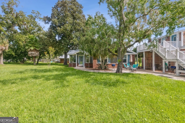 view of yard with stairway and a patio area