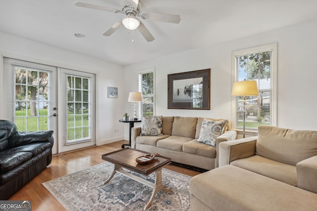 living room with ceiling fan, french doors, baseboards, and wood finished floors