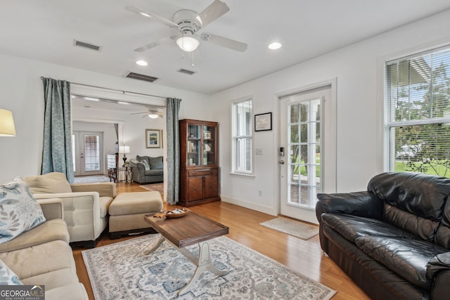 living area featuring recessed lighting, visible vents, baseboards, and light wood finished floors