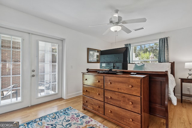 bedroom featuring baseboards, visible vents, access to exterior, french doors, and light wood-type flooring