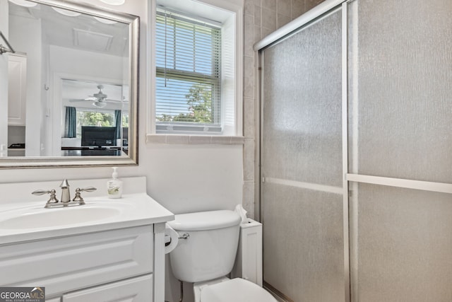 bathroom featuring toilet, a stall shower, and vanity