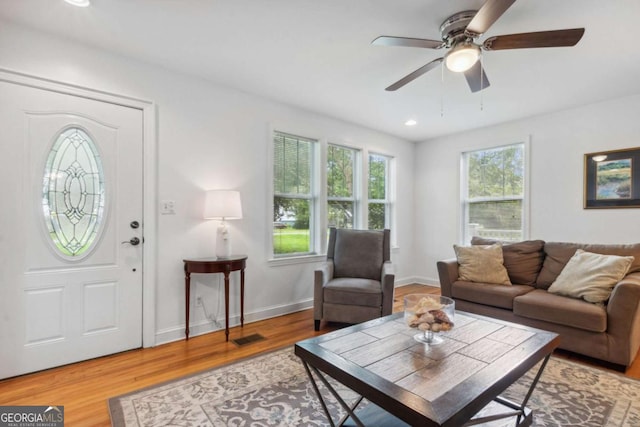 living room featuring recessed lighting, visible vents, baseboards, and wood finished floors