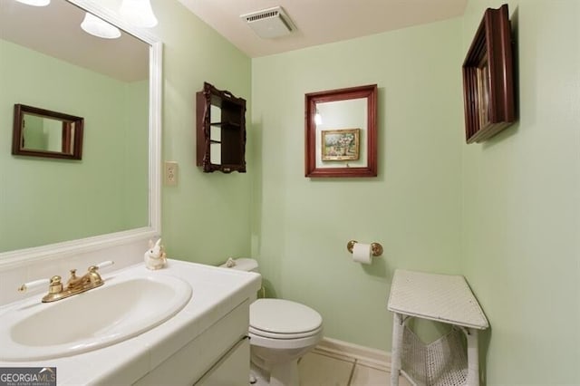 bathroom with tile patterned floors, vanity, and toilet