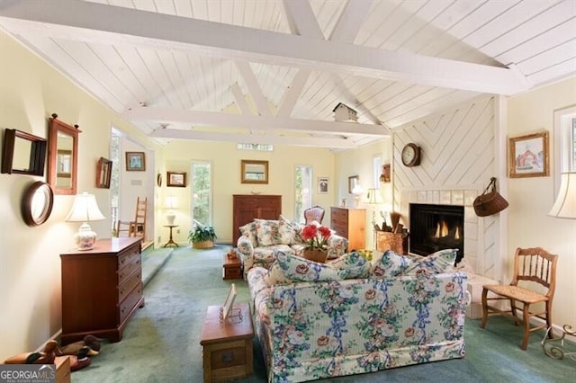 living room featuring vaulted ceiling with beams, carpet, and a brick fireplace