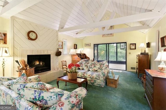 carpeted living room featuring a tiled fireplace and lofted ceiling with beams