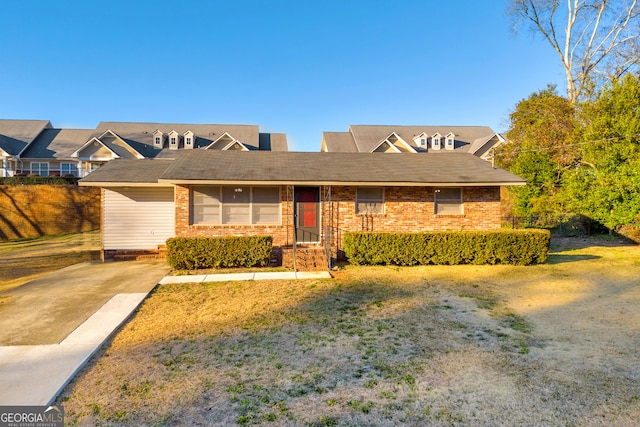 ranch-style home with a front lawn