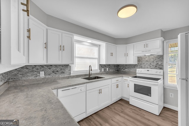 kitchen featuring range hood, white cabinets, white appliances, and sink