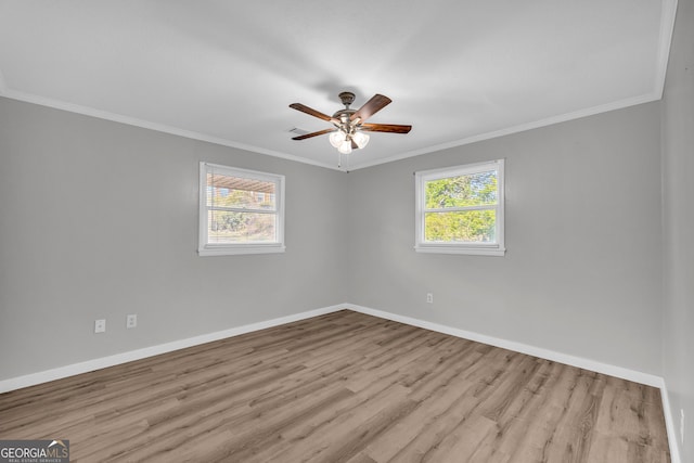 empty room featuring crown molding, light hardwood / wood-style flooring, and ceiling fan