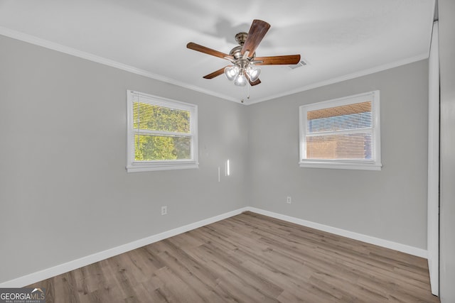 spare room with ceiling fan, crown molding, and light hardwood / wood-style flooring