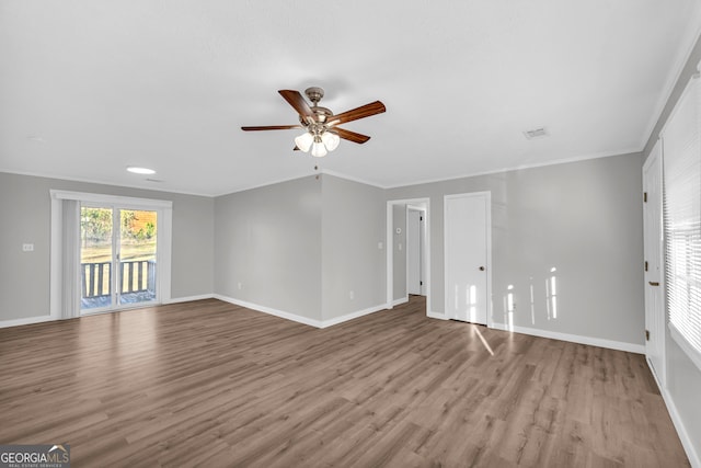 empty room featuring light hardwood / wood-style floors, ceiling fan, and crown molding