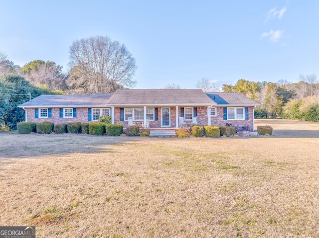 single story home featuring a porch and a front yard