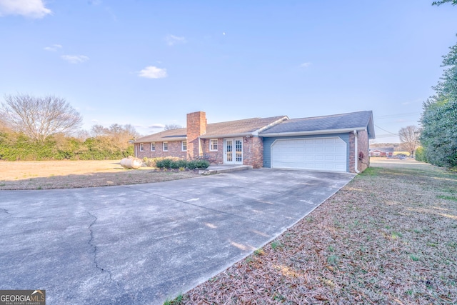 single story home with french doors and a garage