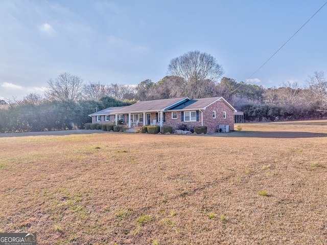 single story home with a porch and a front lawn