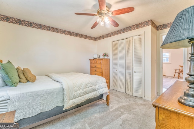 bedroom featuring a closet, ceiling fan, and light colored carpet