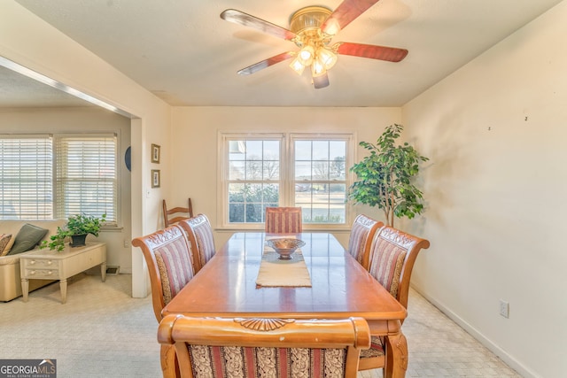 carpeted dining area featuring ceiling fan