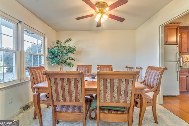 dining room featuring ceiling fan and light hardwood / wood-style flooring