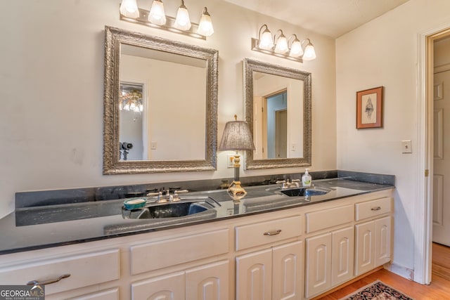 bathroom with hardwood / wood-style floors and vanity