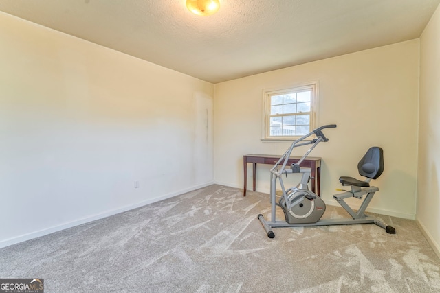 workout area with carpet flooring and a textured ceiling