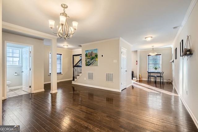 interior space featuring crown molding, dark wood-type flooring, and a notable chandelier