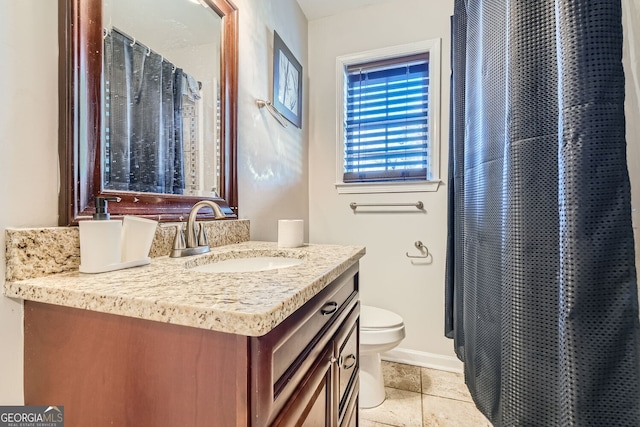 bathroom with tile patterned flooring, vanity, and toilet