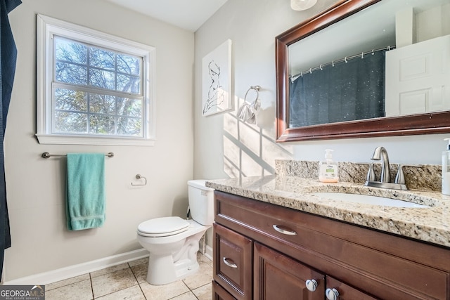 bathroom featuring tile patterned flooring, vanity, and toilet