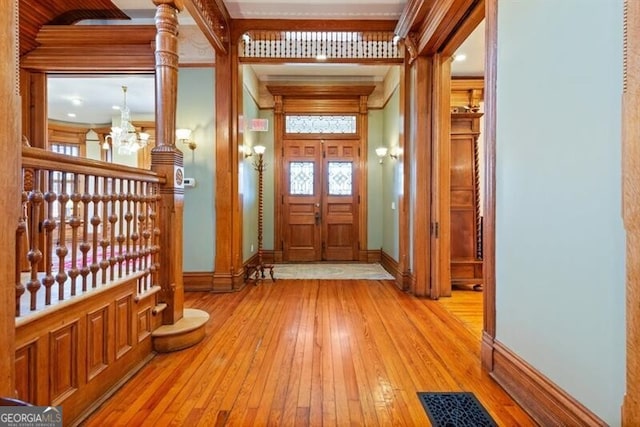 interior space with light hardwood / wood-style floors and a notable chandelier