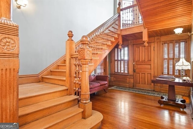 staircase with wood-type flooring and wood ceiling