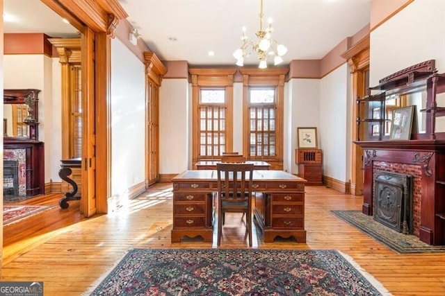 office space featuring a notable chandelier and light hardwood / wood-style flooring