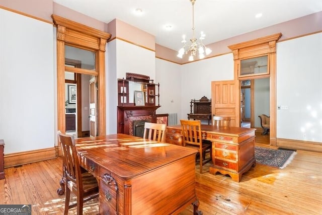 dining room featuring light hardwood / wood-style flooring and an inviting chandelier