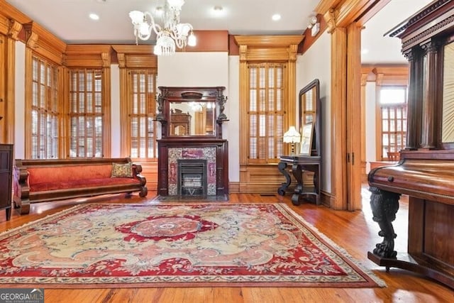 living area featuring a notable chandelier and light wood-type flooring