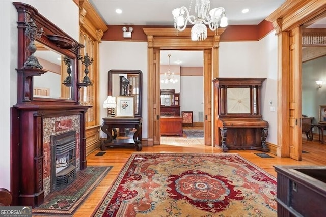 sitting room with light wood-type flooring and a notable chandelier