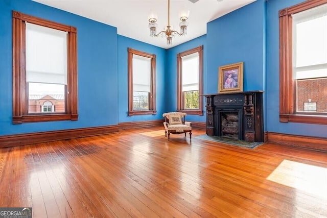 living area featuring light hardwood / wood-style floors and a notable chandelier