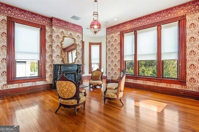 sitting room with a fireplace and wood-type flooring