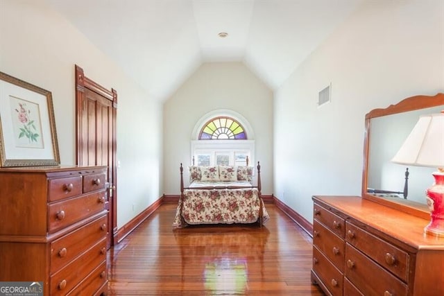 bedroom featuring dark hardwood / wood-style floors and lofted ceiling