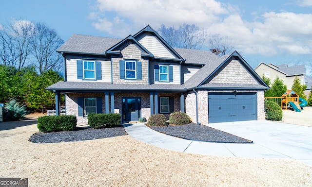 craftsman house featuring covered porch, a garage, and a playground