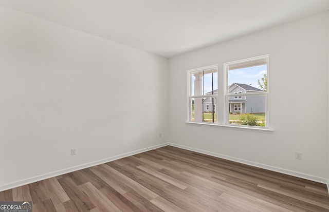 unfurnished room with light hardwood / wood-style flooring