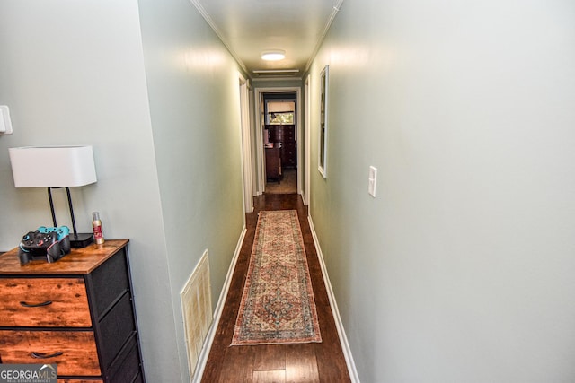 hallway featuring crown molding and hardwood / wood-style flooring