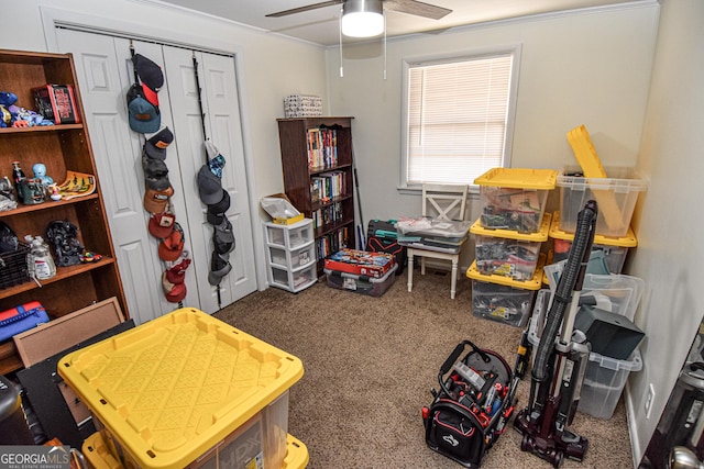 playroom with dark carpet, ceiling fan, and crown molding