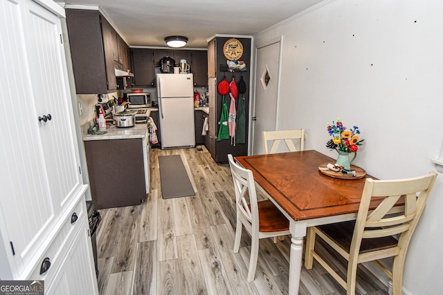 dining space featuring light hardwood / wood-style floors and ornamental molding