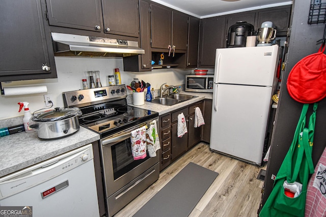 kitchen featuring light wood-type flooring, sink, and appliances with stainless steel finishes