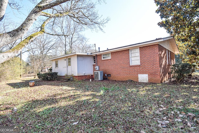 rear view of house with central AC unit