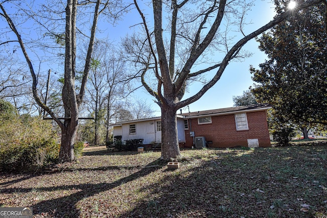 rear view of property with central AC