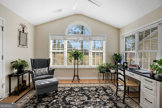 office area with light hardwood / wood-style floors and lofted ceiling