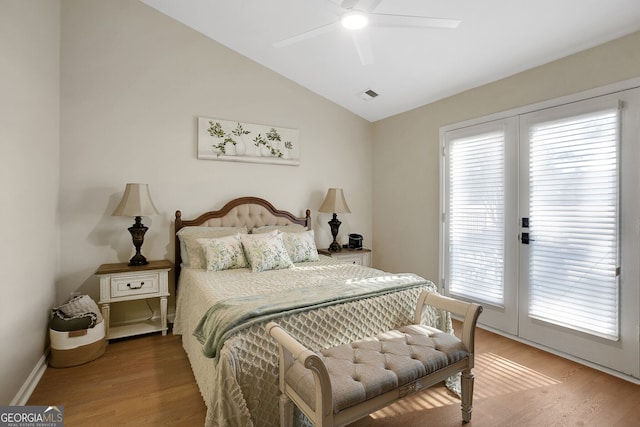 bedroom featuring hardwood / wood-style flooring, ceiling fan, access to exterior, and multiple windows