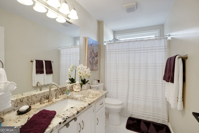 bathroom featuring tile patterned floors, vanity, and toilet